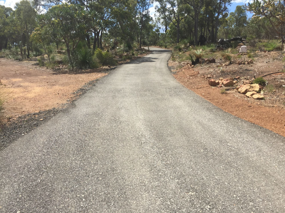 This is a photo of a hot spray & seal bitumen driveway which is in the process of being installed by Werribee Road Tech