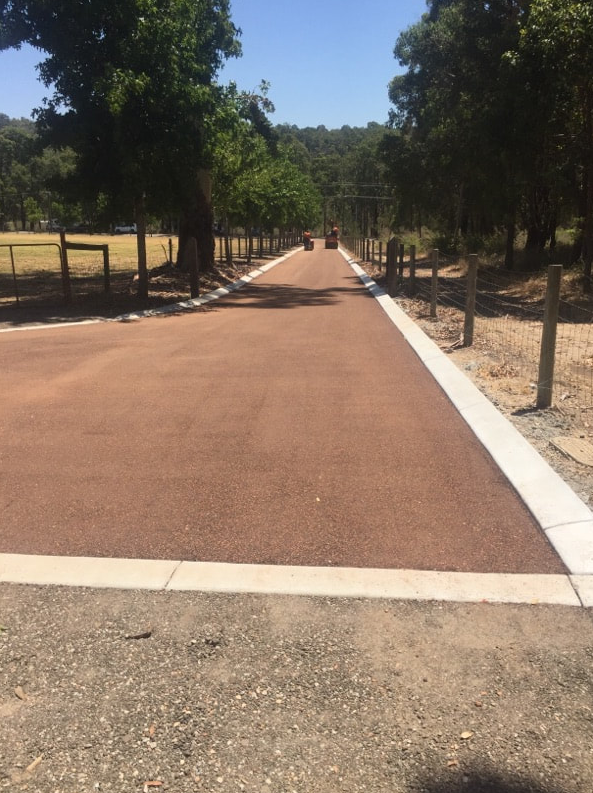 This is a photo of a hot spray & seal bitumen roadway which is in the process of being installed by Werribee Road Tech